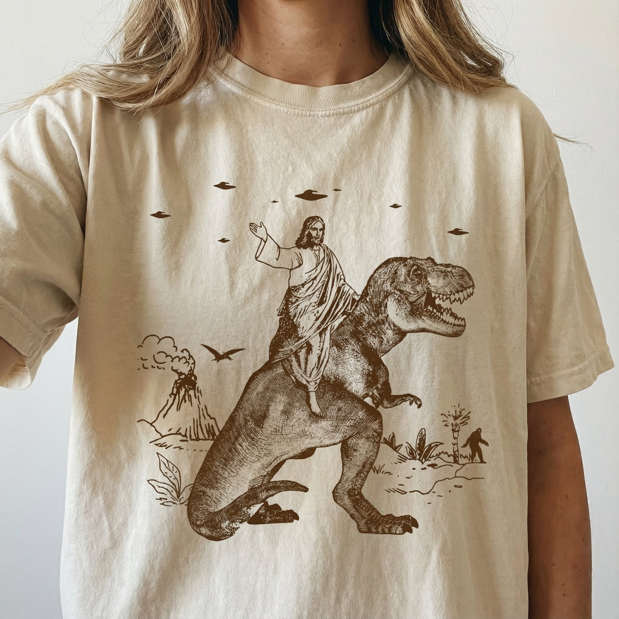 Jesus Riding Dinosaur Graphic T-Shirt - Funny UFO Novelty Tee 