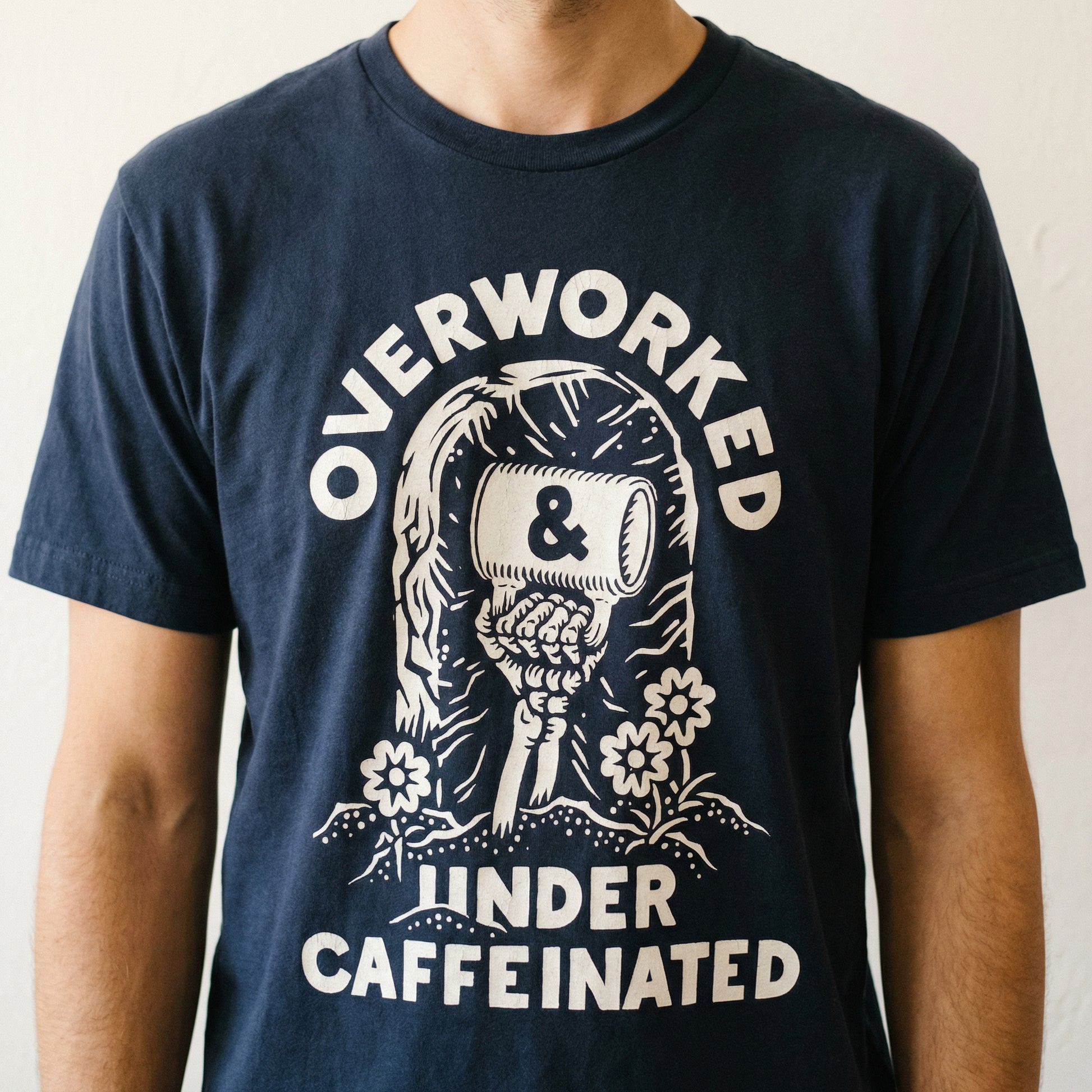 Overworked Under Caffeinated Graphic T-Shirt – Funny Coffee Lover Tee